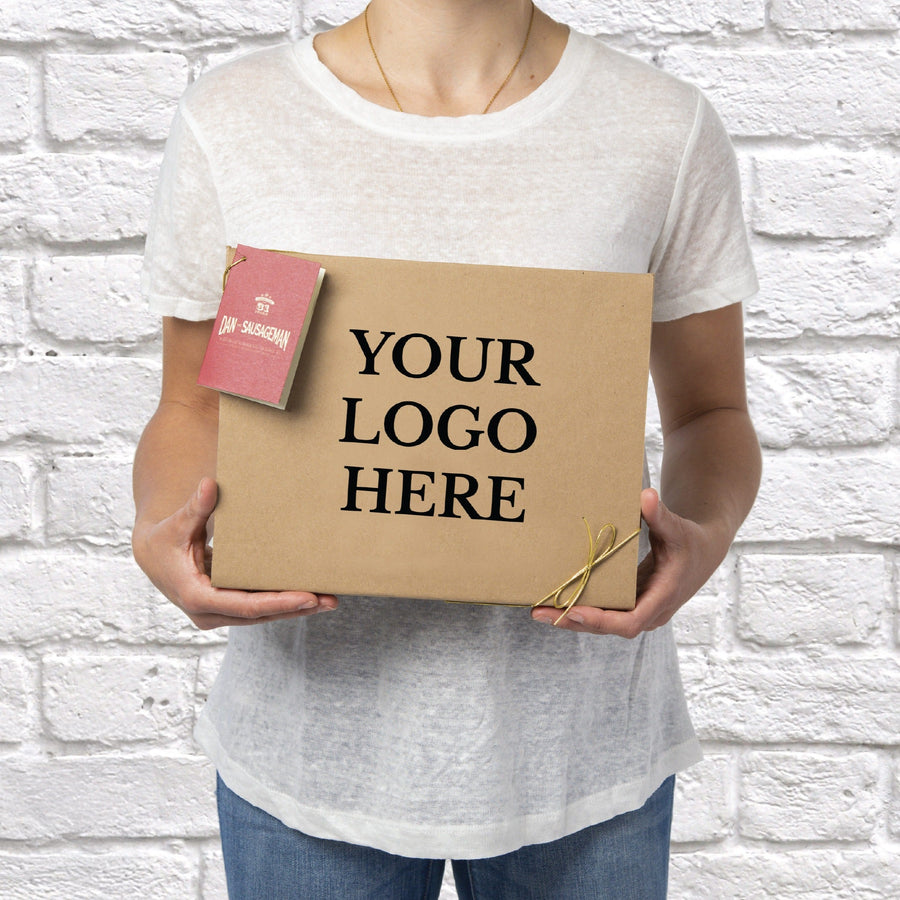 Person holding a kraft gift box with a Your Logo Here customization example