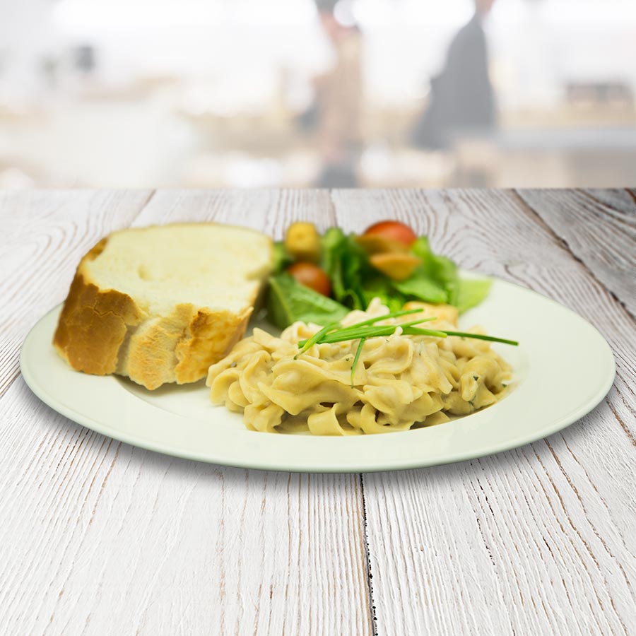 Prepared pasta Alfredo with vegetables and bread, serving suggestion