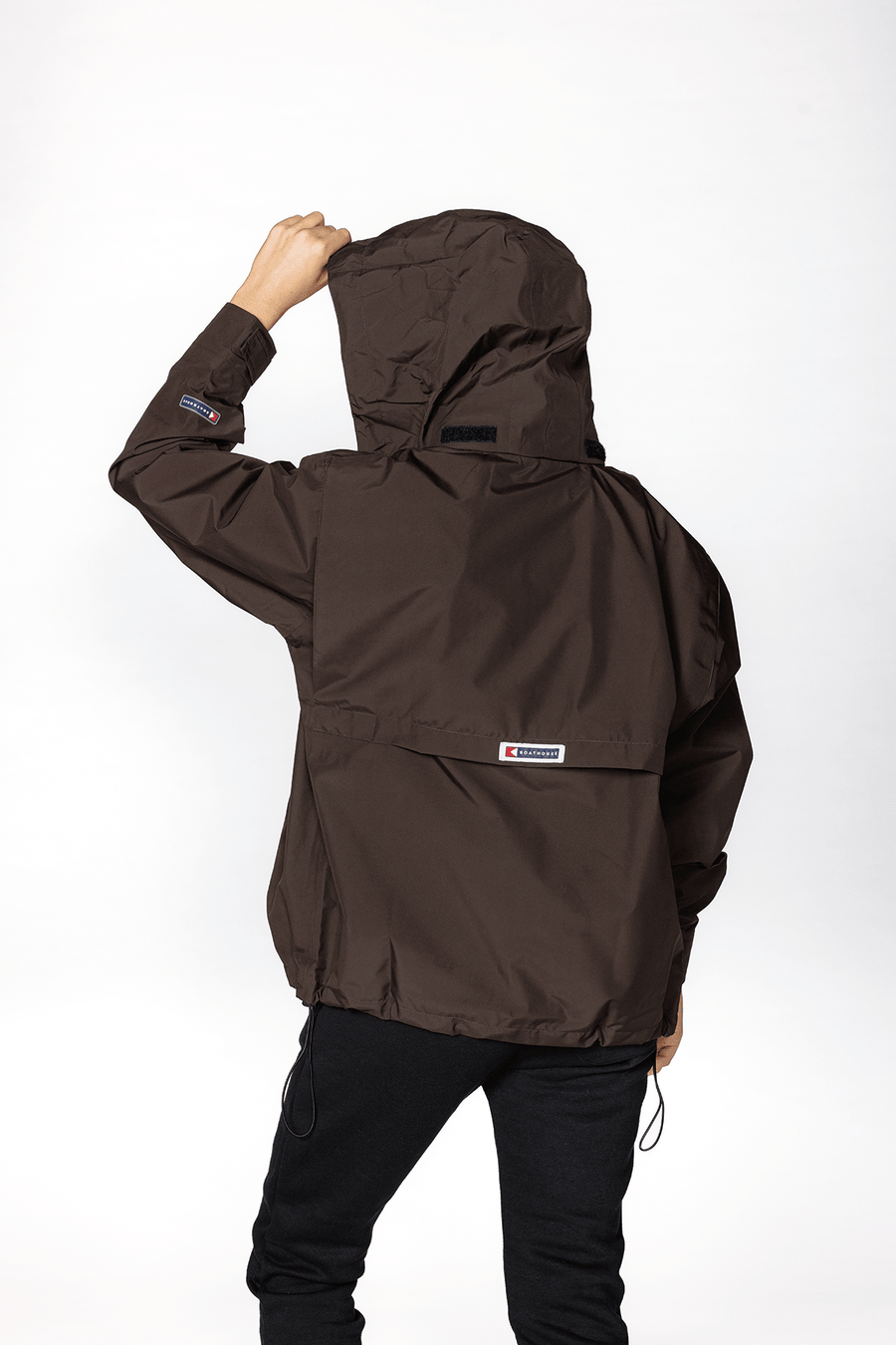 Blitz Waterproof Jacket: model wearing brown shell, back view.
