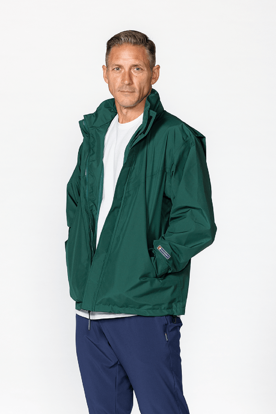 Blitz Waterproof Jacket: model wearing forest green shell.