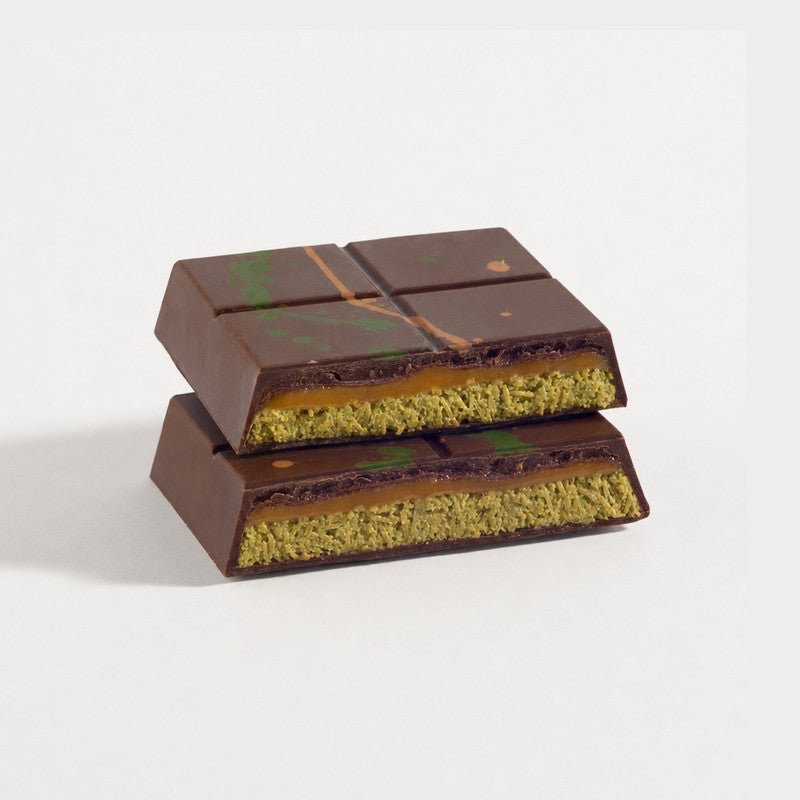 Cut pistachio caramel Dubai bar showing its layered filling