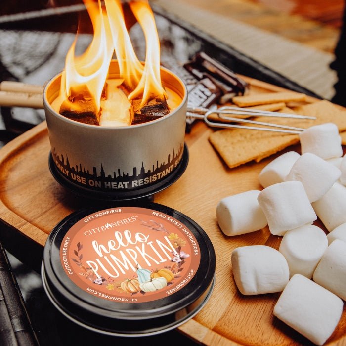 Hello Pumpkin lid beside a bonfire and s’mores ingredients