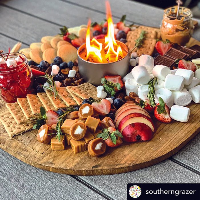Bonfire surrounded by a snack and s’mores serving board