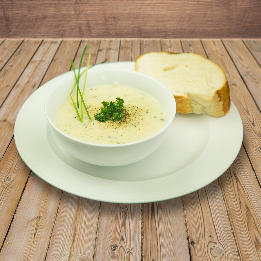 Prepared creamy soup with bread, serving suggestion