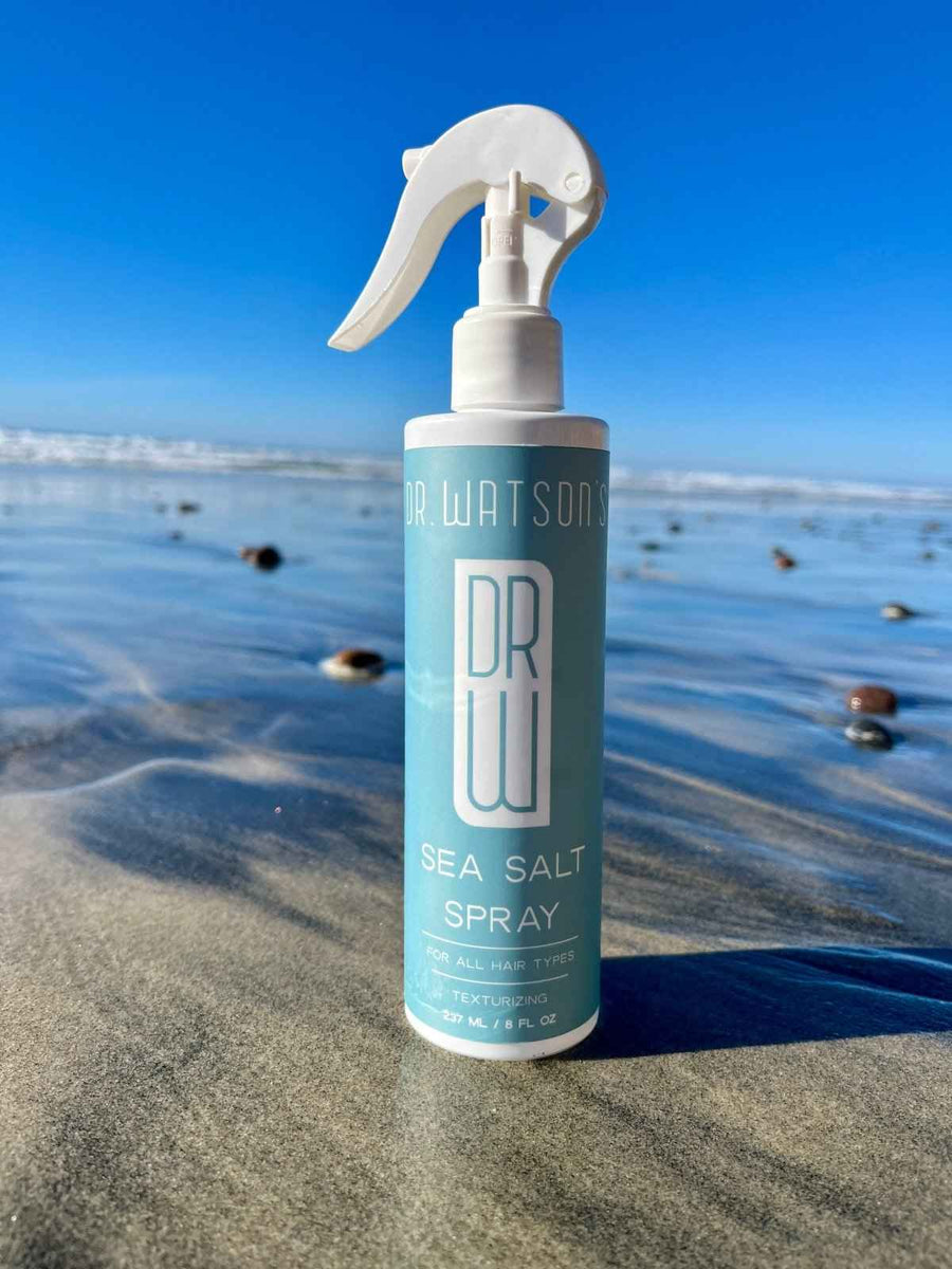 Sea salt spray bottle beside ocean surf