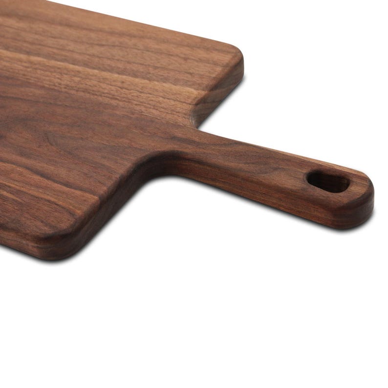 Wide walnut paddle detail showing the handle and hanging hole