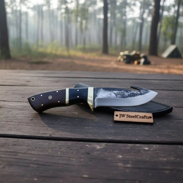 Gut hook knife with wood and brass handle.