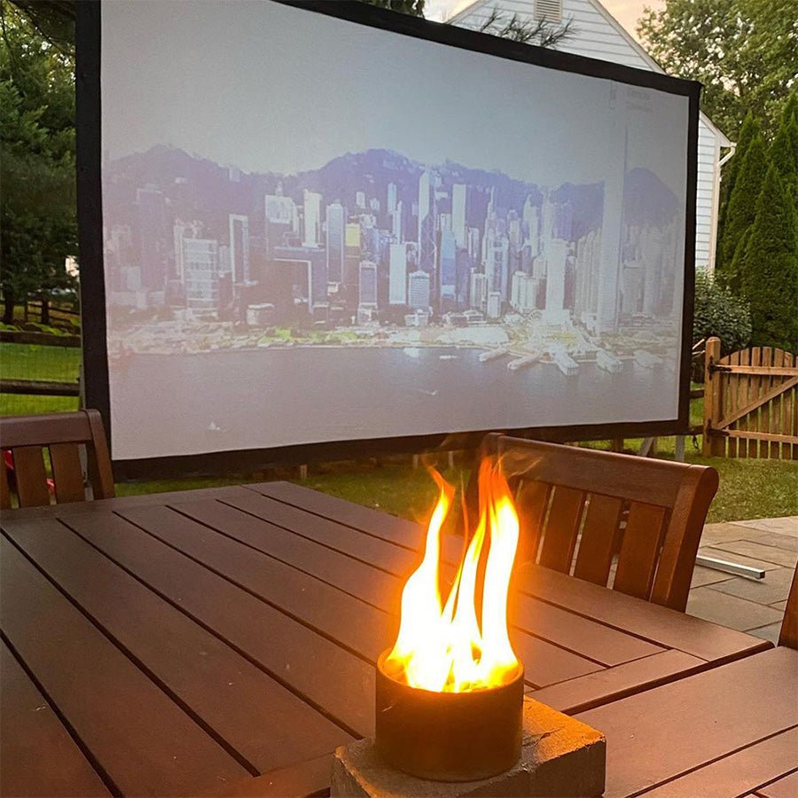 Portable bonfire beside an outdoor movie screen