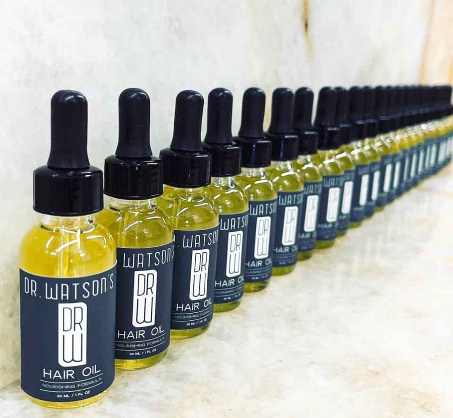 Row of Dr. Watson's hair oil dropper bottles