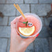 hand holding iced lemonade with cocktail wheat straw