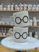 A stack of handmade ceramic mugs capturing the magic of a familiar wizarding world, each featuring classic round glasses and a golden lightning bolt. Perfect for cozy moments filled with charm and nostalgia.
