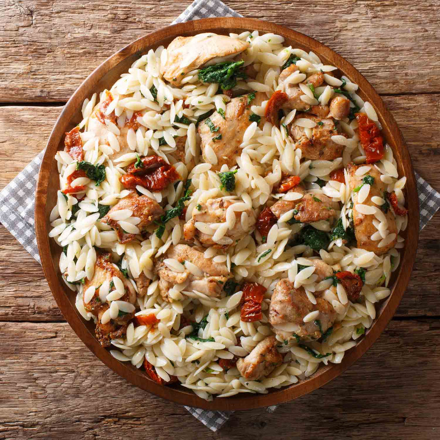 Lupin & Sunflower Protein Orzo Pasta: prepared orzo dish in a wooden bowl.