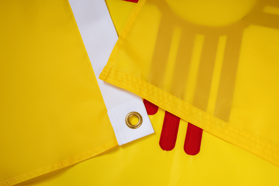 New Mexico State Flag fabric, white heading, and brass-tone grommet