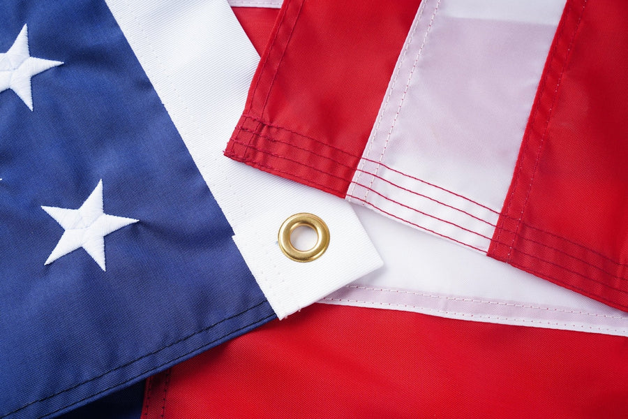 Embroidered stars, sewn stripes, and grommet on an American flag
