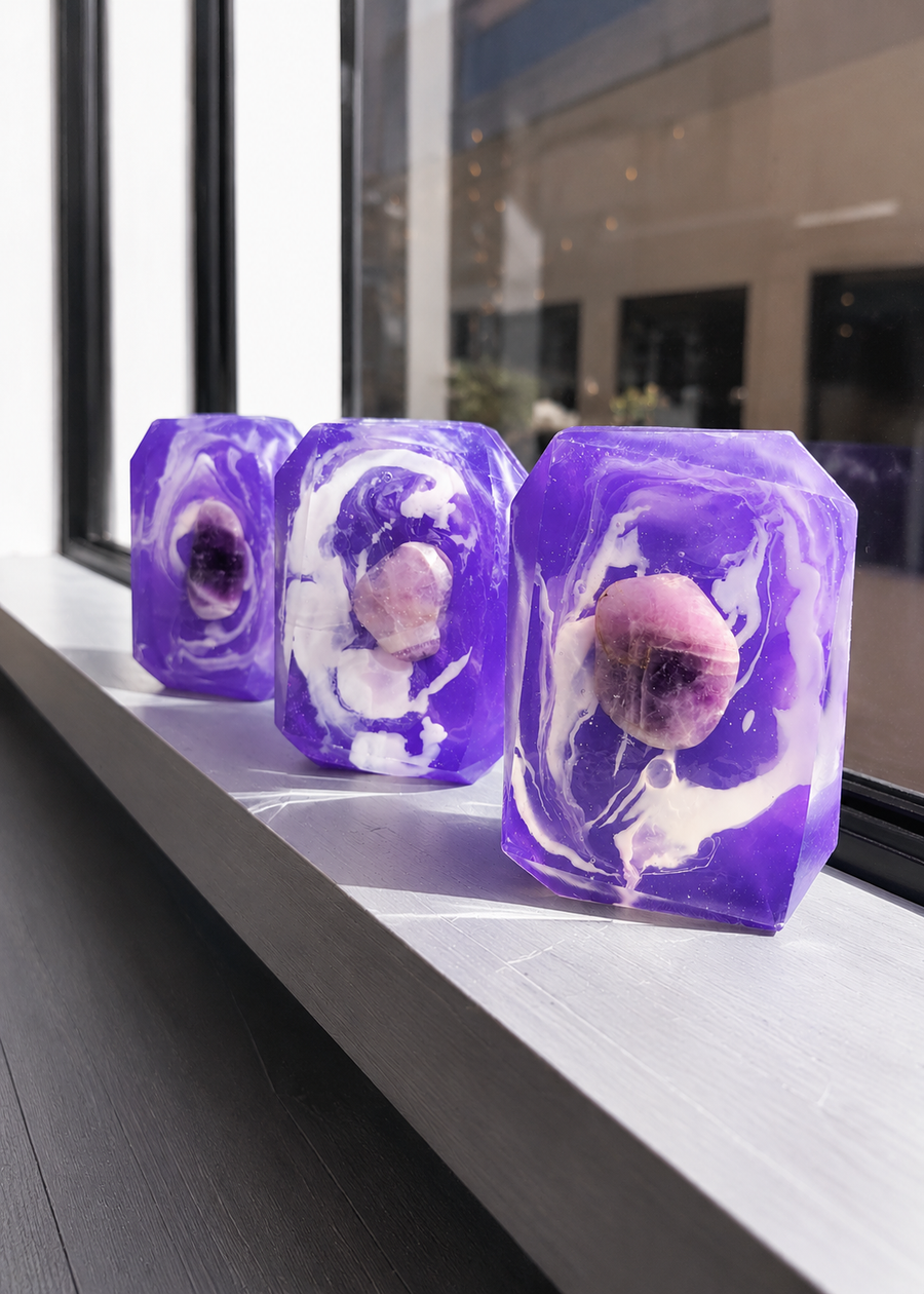 Several Peace Bridge purple and white soap bars on a windowsill