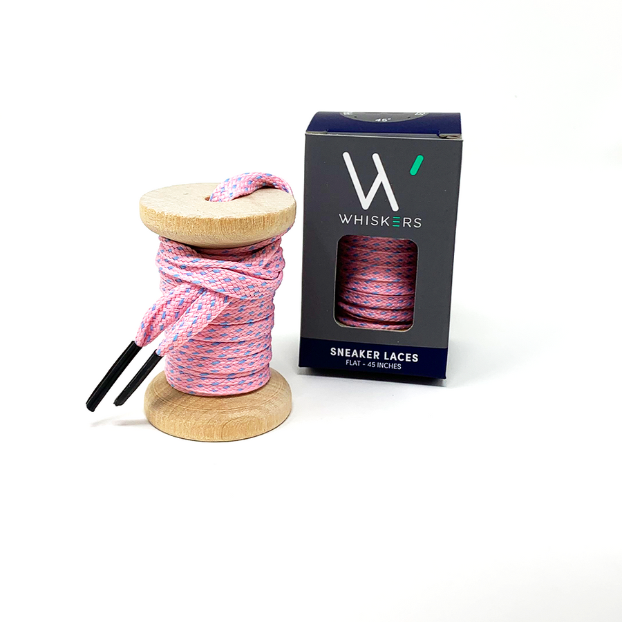 Pink & Light Blue ticked flat shoelaces on a wooden spool beside the retail box