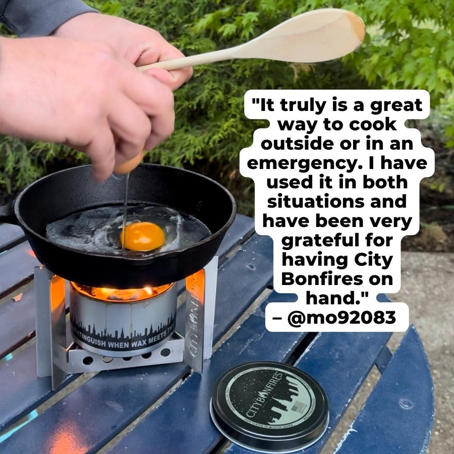 Person cooking an egg over a bonfire with the camp stove
