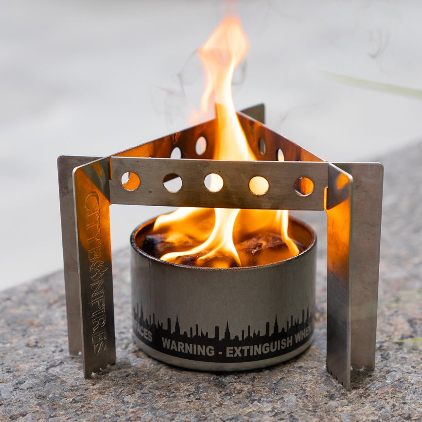 Close view of the camp stove around a lit bonfire