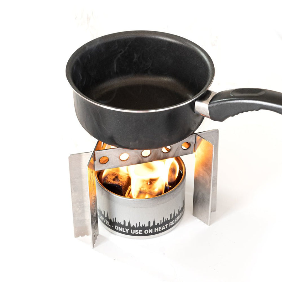 Cooking pot over a bonfire in the stainless steel stove