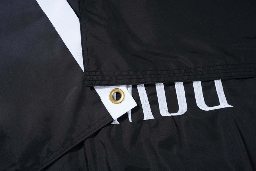 POW/MIA flag fabric, white heading, and grommet