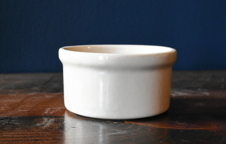 Bristol off-white stoneware ramekin for baking and serving on a wood surface