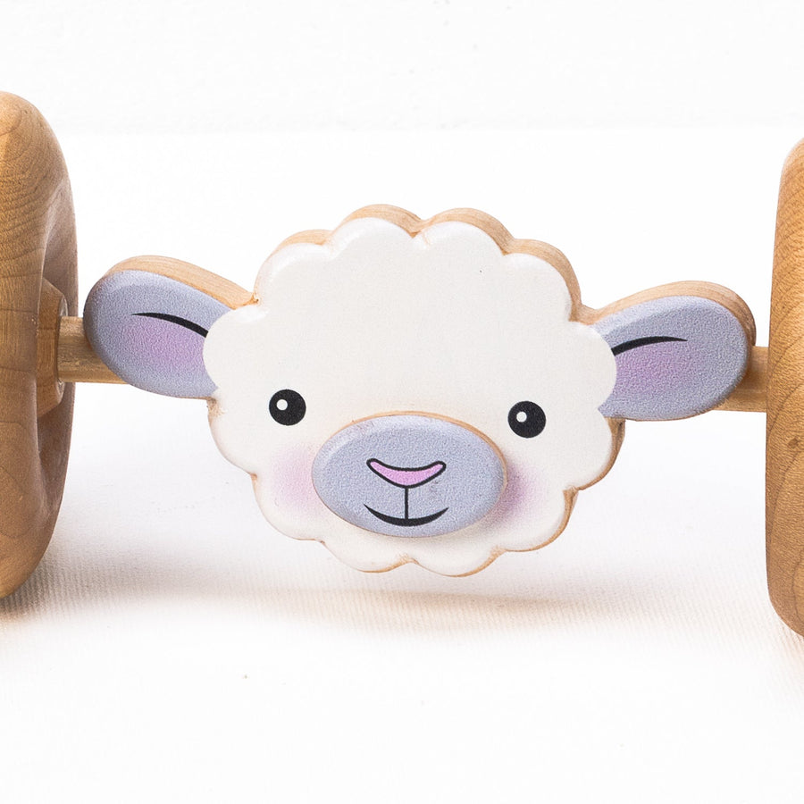 Sheep-face detail on a wooden rolling animal toy