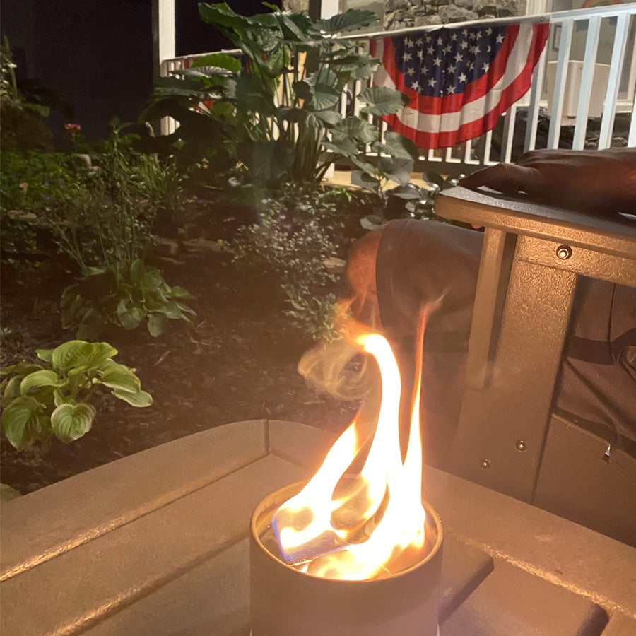 Portable bonfire burning on an outdoor deck setting
