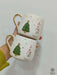 A festive pair of handmade ceramic mugs featuring a delightful snowman and Christmas tree design, with subtle golden accents for an added touch of elegance. Perfect for cozying up with a warm drink during the holiday season or sharing holiday cheer with loved ones.