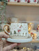 Snowman-themed handmade ceramic espresso cup with gold accents and matching saucer. Perfect for festive coffee moments.