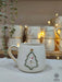 This festive mug features a snowman in a Christmas tree frame with gold accents, perfect for adding holiday cheer or gifting loved ones!