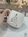 A handmade Star Trek-inspired ceramic Christmas mug featuring a 3D Christmas tree with colorful baubles, a gold star, and a gold handle, perfect for Trekkie fans.