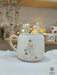 A handmade Star Trek-inspired ceramic Christmas mug featuring a 3D Christmas tree with colorful baubles, a gold star, and a gold handle, perfect for Trekkie fans.