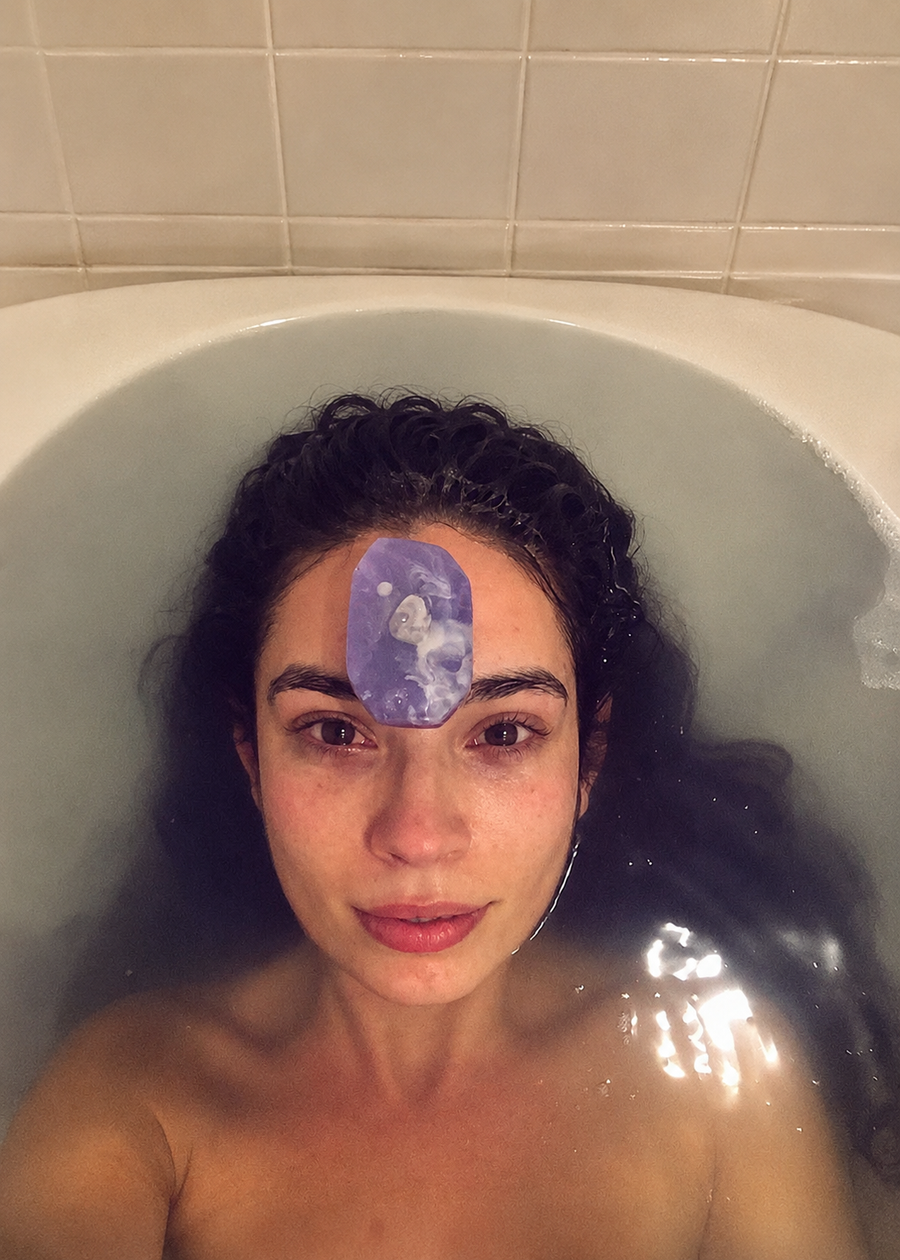 Person in a bath with a Peace Bridge soap bar held against the forehead