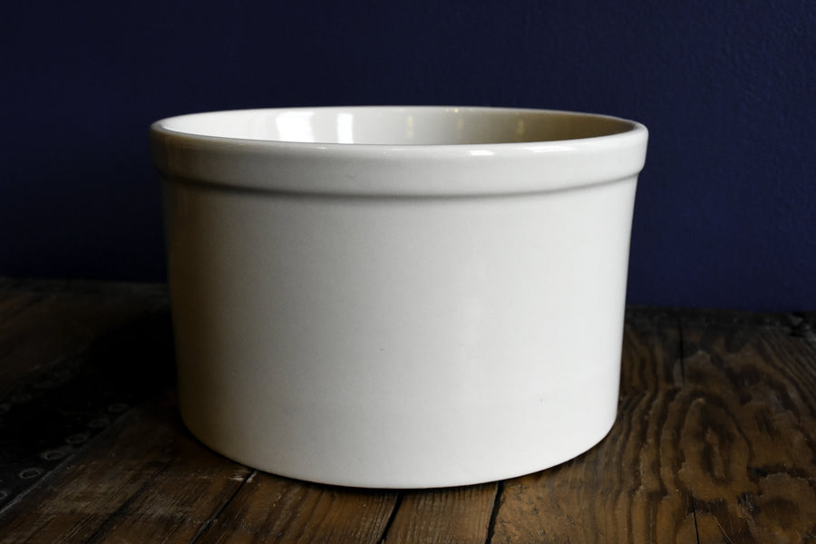 Bristol off-white stoneware utility crock - 2 quart low profile on a wood surface